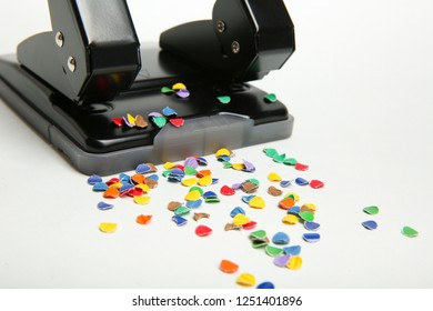 A Part Of Office Hole Punch With Confetti On White Background