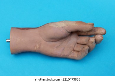 Part of the old artificial hand on blue background top view. - Shutterstock ID 2210473885