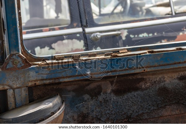 Part of an old\
rusty car, auto repair\
concept.