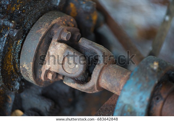 Part of the old rusty gearbox
and drive shaft with grunge oil dirty, Vintage engine car
system.