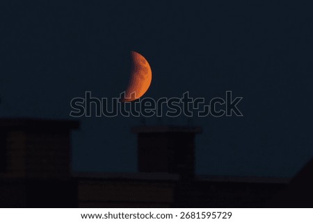 The part is only covered by shadow. The lunar eclipse or blood moon photo in the night sky.