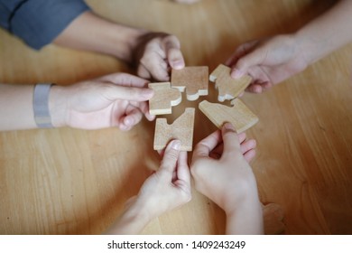 Part and parcel of business. Close-up of many people holding puzzle elements close to each other - Shutterstock ID 1409243249