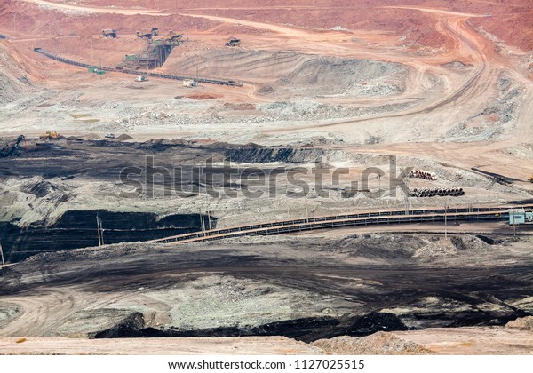 Part of a pit with\
big mining truck working