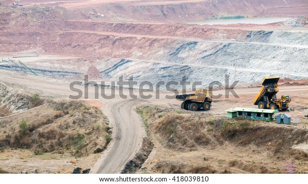 Part of a pit with\
big mining truck working