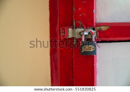 Part of red box with a latch and lock. Box mounted in to wall.