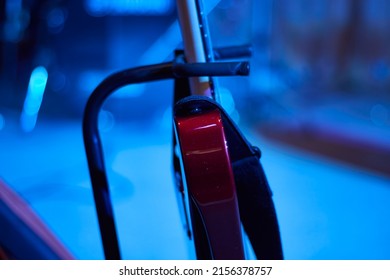 Part Of A Red Guitar Standing On A Guitar Stand.