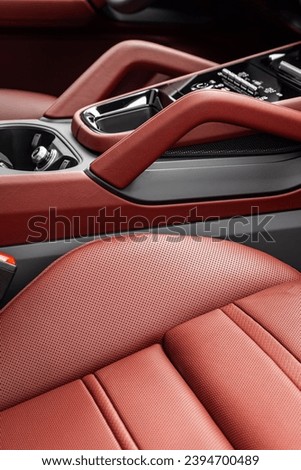 Part of  red leather car seat details. Сlose-up perforated leather car seat. Skin texture