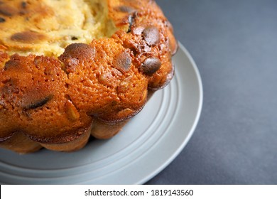 Part Of A Round Pie With Pumpkin Seeds From Corn And Rice Flour On A Gray Plate On A Black Background Side View . Gluten Free Baked Goods Made At Home