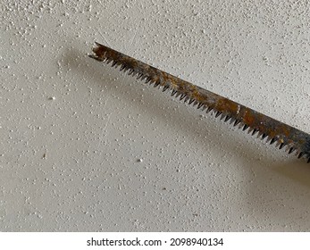 part of saw blade teeth on white background . blade of saw. small and big saw.small and large teeth of an old saw