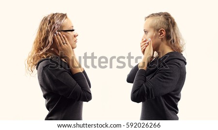 Part of series .Self talk concept. Young blond caucasian woman talking to herself, showing gestures. Double portrait from two different side views.