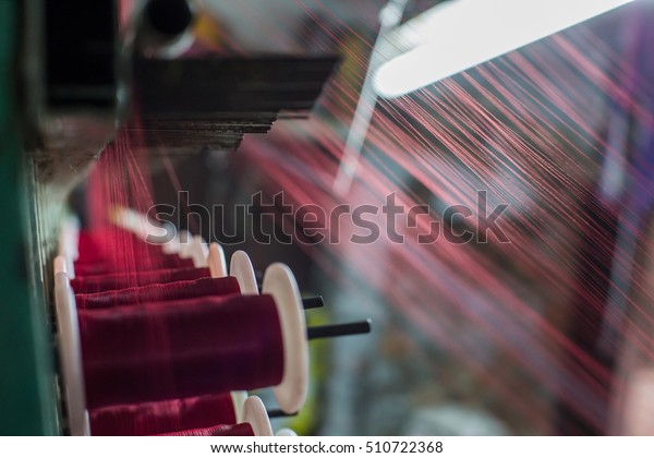 Part of the silk weaving loom with thread reels in\
Varanasi city. India. 
