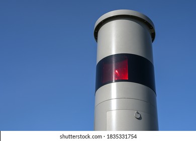 Part of a stationary speed limit enforcement with light radar, red flash and camera, traffic monitoring against dangerous speeding, blue sky, copy space