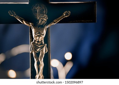 Part of the statuette with the Crucifixion of Jesus Christ, at close range, in the dark, with place for text, without nobody, a symbol of suffering, mercy, sacrifice and God's love