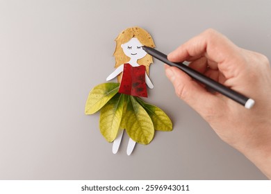 part of Step-by-step creation of paper and leaf doll for autumn crafts. DIY nature handmade artwork using dried leaves, paper cutouts. Perfect for educational materials, creative workshops