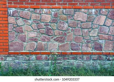 Part stone   brick wall in green grass