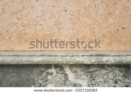 Part of the stone house is made in two colors - yellow and gray. Texture of an uneven surface with space to copy. High quality photo