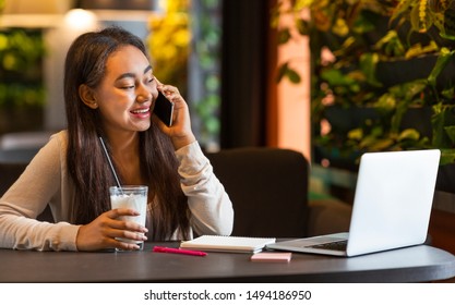 Part Time Job. Cheerful Teen Girl Working At Cafe, Talking By Phone, Copy Space