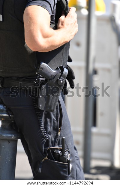 Part\
view of a german policeman. A gun in the\
holster.