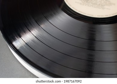 Part Of Vinyl Record Playing On Old Turntable. Detail Of Vinyl LP Showing Texture And Music Tracks