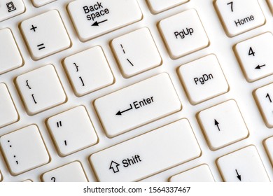 Part of a white keyboard for a computer. Enter key close up. The concept of social networks and information communication. Background for digitalization design and computer literacy.