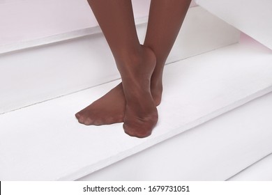 Part Of Woman Body Toes Foot Sock Legs Skin Tan Wear Stockings, Nylons, Pantyhose Lingerie Hosiery Hose Beige Studio Shot On White Background Stairs .