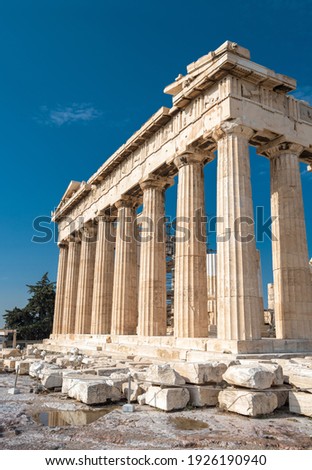 Parthenon temple on Acropolis, Athens, Greece. Vertical view of famous building ruins on Acropolis top, Ancient Greek architecture of Athens, World landmark. Concept of antique and travel in Athens.