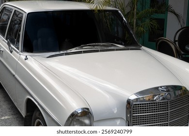 Partial angled front view photo of a white car with tinted window