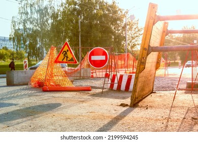 partial closure of the roadway for the period of repair and restoration work, the removed Trench shoring stands nearby, selective focus and backlight - Shutterstock ID 2199594245