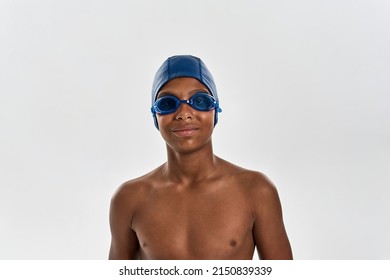 Partial Image Of Smiling Black Boy Swimmer Looking At Camera. Male Youngster Wearing Swimming Cap And Goggles. Modern Child Sportive Lifestyle. Isolated On White Background. Studio Shoot. Copy Space