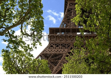 Similar – Eiffel Tower in green trees on blue sky