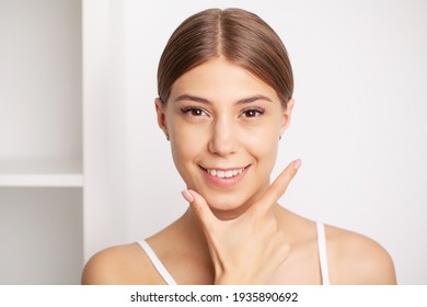 Partial portrait of girl with strong white teeth looking at camera and smiling