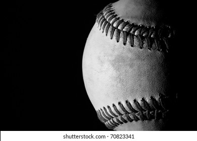 Partial Shot Of A Baseball In Black And White Against A Black Background