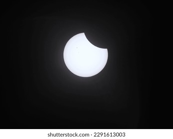 Partial solar eclipse at the beginning, Banjarbaru, Indonesia, April 20 2023 at 11.03 o'clock. Captured by camera with solar filter