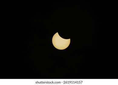 Partial solar eclipse captured against dark sky