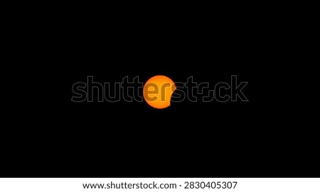 Partial solar eclipse with orange sun and lunar silhouette against black sky