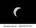 Partial solar eclipse sequence, Phase 4 of 7: quarter sun phase seen from Brookwood, Surrey, UK. Shot with Canon 5DSR, Canon 100-400mm L, 640mm equivalent. A sharp astronomical photograph capturing the three quarter-eclipse phase of the partial solar eclipse on August 12, 2026. The moon covers approximately three quarters of the solar disc, creating a striking quarter-sun silhouette isolated against a black background.