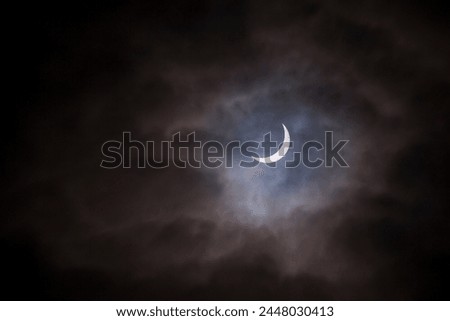 A partial solar eclipse taken on a cloudy day.
