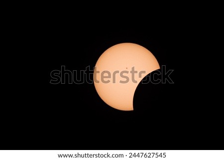 Partial Solar Eclipse with visible sun and moon without corona. Sunspots visible. Photo of solar eclipse with Neutral density filter