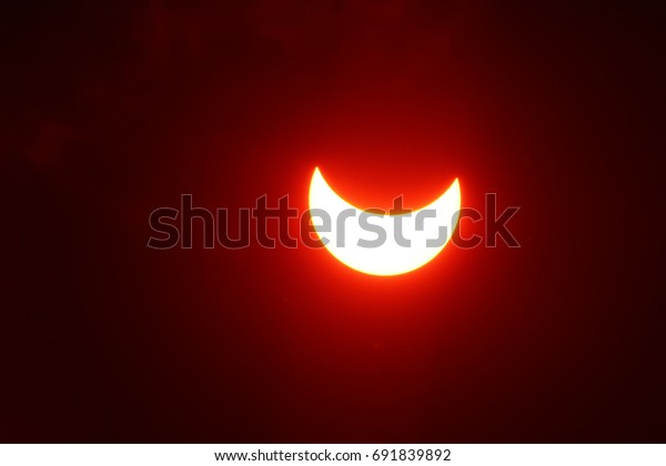 Partial Solar moon\
Eclipse on a Cloudy Day