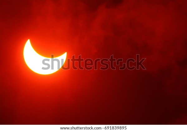 Partial Solar moon\
Eclipse on a Cloudy Day