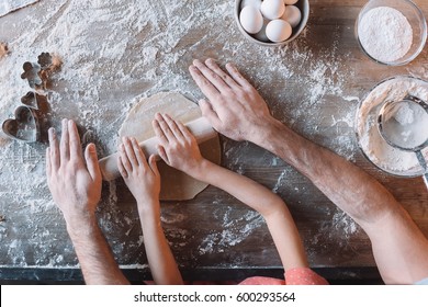 'Partial Top View Of Father And Daughter Kneading Dough Together