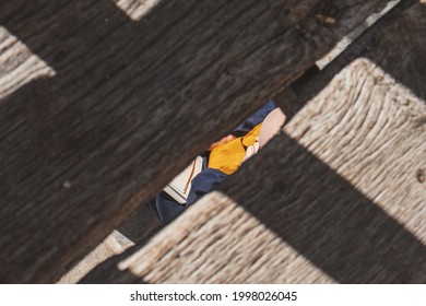 Partial top view of a Zen Buddhist monk reading.