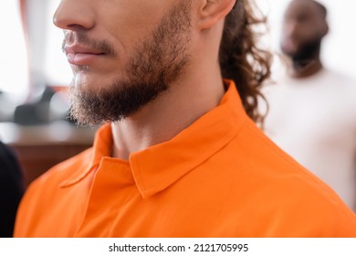 Partial View Of Bearded Man In Jail Uniform Near African American Juror On Blurred Background