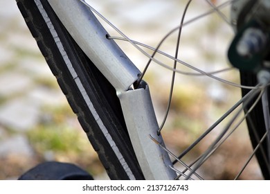 Partial view of a broken aluminum rim of a bicycle. 