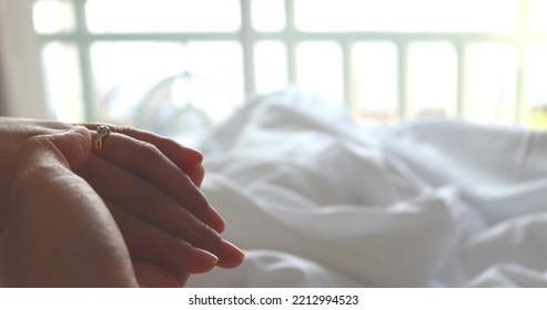 Partial View Of Couple In Love Holding Hands While Lying In Bed White.