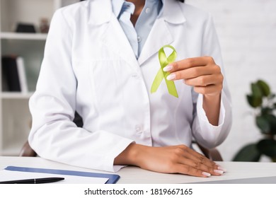 Partial View Of Doctor Holding Green Awareness Ribbon, Mental Health Concept