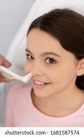 Partial View Of Ent Physician Examining Nose Of Smiling Kid With Nasal Speculum