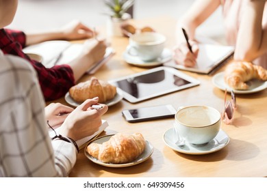partial view of group of friends study together in cafe