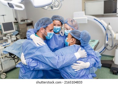 Partial View Of Hard-working Male And Female Hospital Team In Full Protective Wear Standing Together In Group Embrace