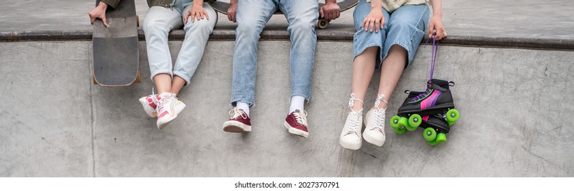 Partial View Of Interracial Skaters In Sneakers Sitting On Skate Ramp, Banner